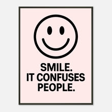 Smile Blush Pink wall art poster in black metal frame featuring minimalist smiley face and bold typography quote design