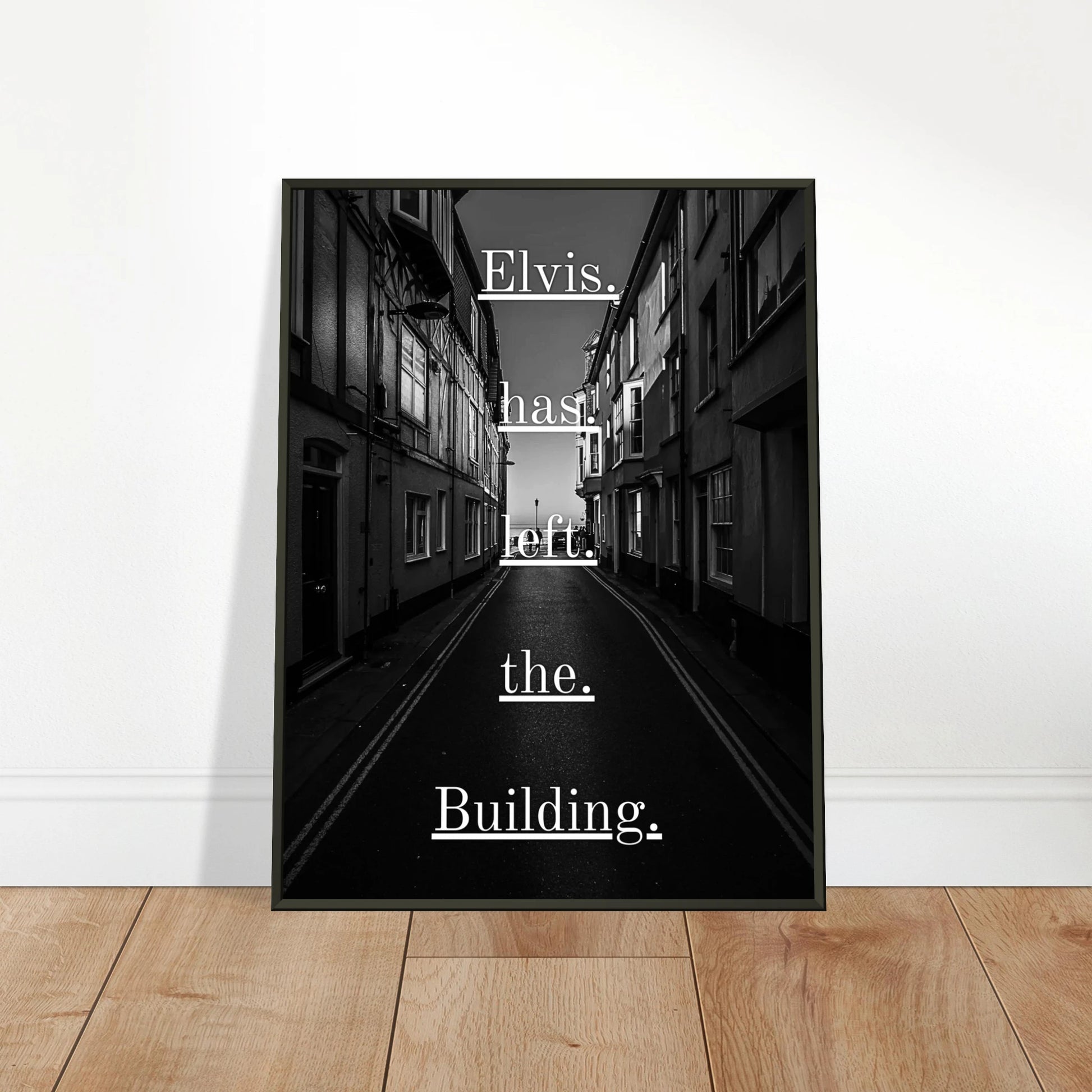 Elvis Has Left the Building wall art poster leaning against wall in black metal frame modern music interior mockup