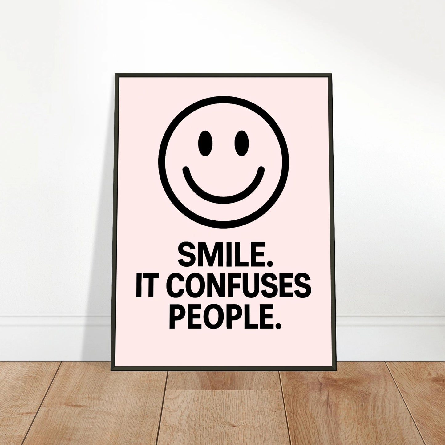 Smile Blush Pink wall art poster leaning against wall in black metal frame modern hallway decor mockup