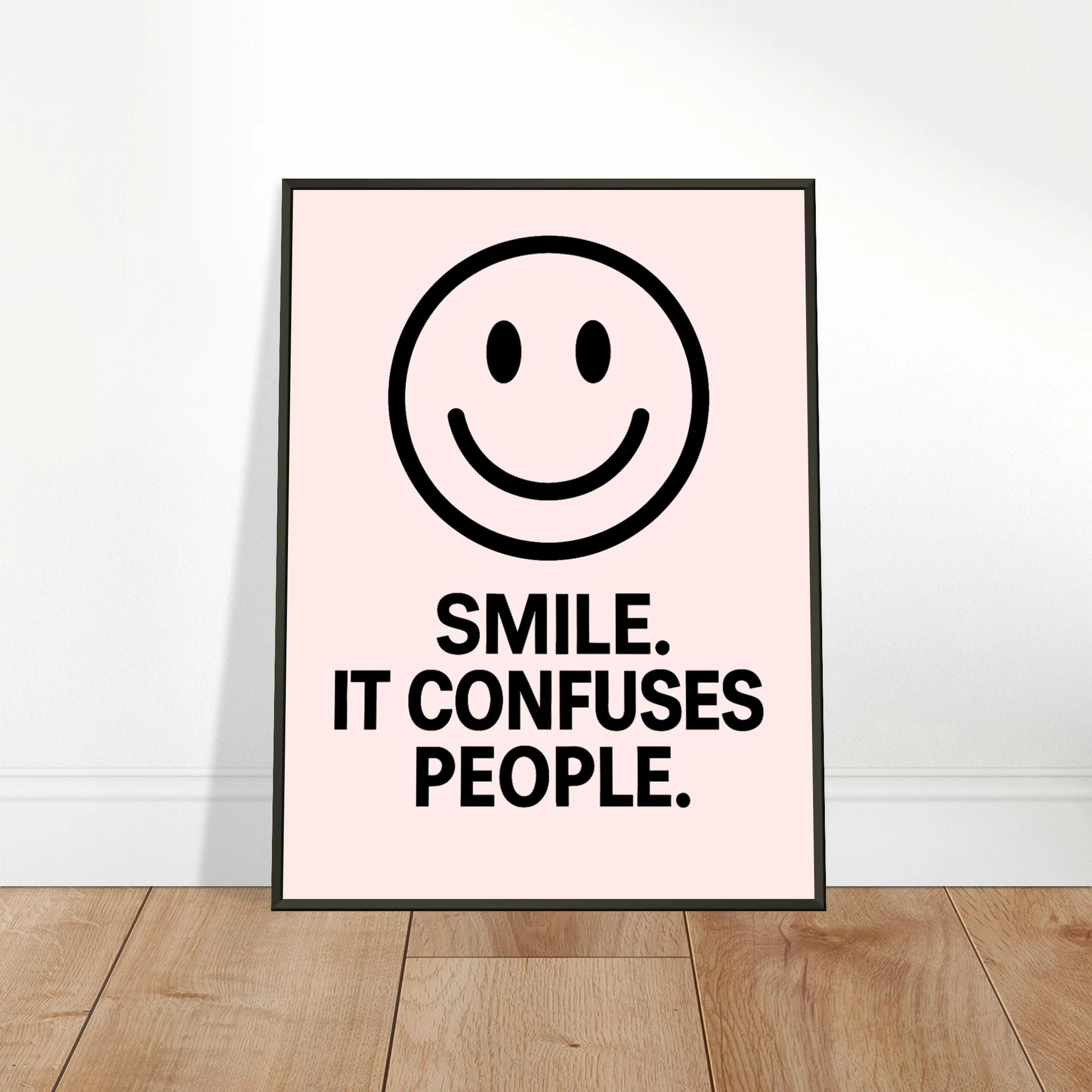 Smile Blush Pink wall art poster leaning against wall in black metal frame modern hallway decor mockup