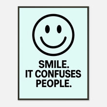 Smile ice blue wall art poster in black metal frame featuring minimalist smiley face and playful typography quote