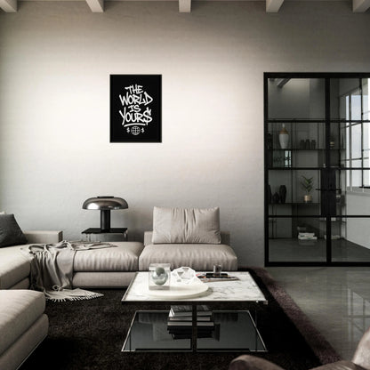 The World Is Yours motivational poster in black metal frame styled in dark modern living room setting